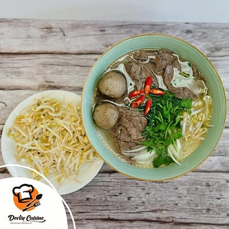 Beef ball pho with chili and cilantro, served with a plate of bean sprouts